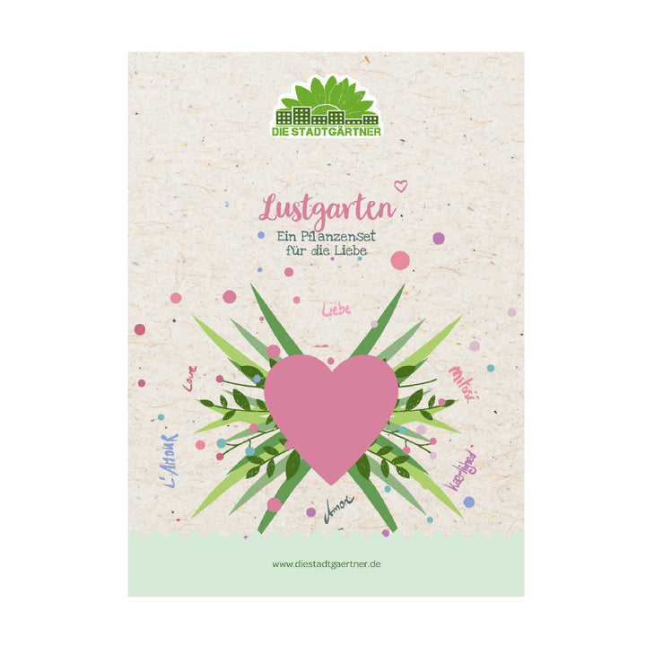 Verpackung eines Pflanzensets mit einem großen rosa Herz, grünen Blättern und dem Schriftzug „Lustgarten – Ein Pflanzenset für die Liebe“ auf beige Hintergrund.