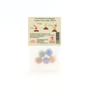 Tüte mit fünf bunten Saatkugeln in Blau, Grün, Gelb und Rot, Verpackung mit Beschreibung und Illustrationen auf Deutsch.