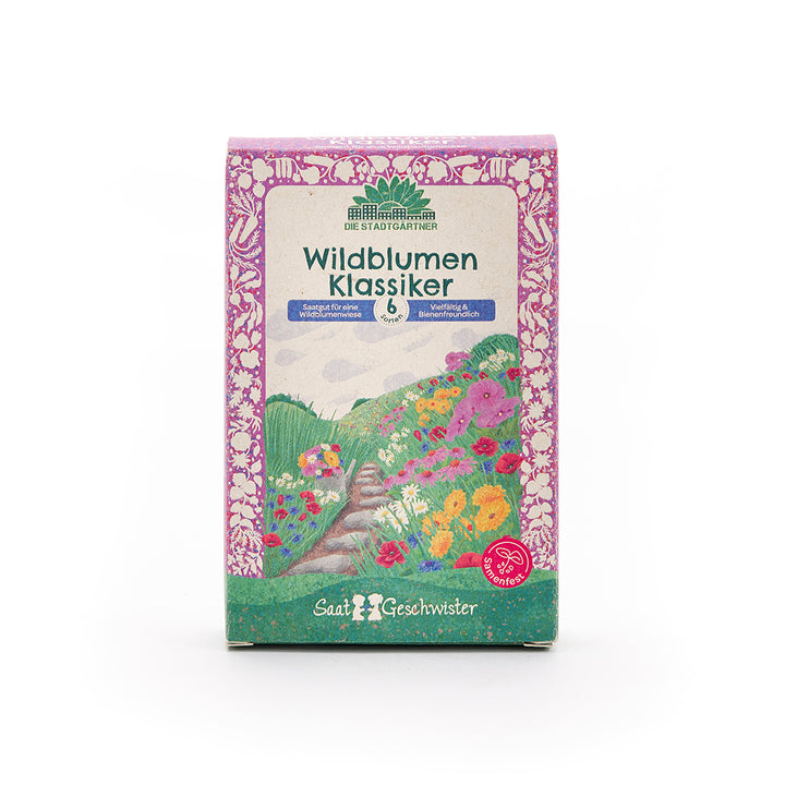 Verpackung mit Aufschrift „Wildblumen Klassiker“ von Die Stadtgärtner, mit bunten Blumenillustrationen und lila Rahmen.