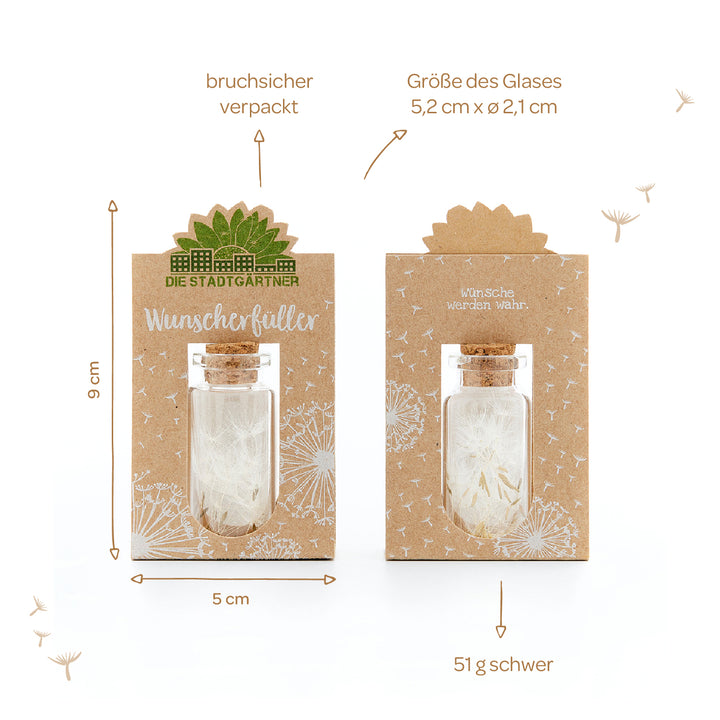 Verpackung von "Die Stadtgärtner Wunschfüller" bestehend aus einem kleinen Glas in einer Papphülle und Pusteblumen-Design, mit Maßangaben und Gewichtsinfo.
