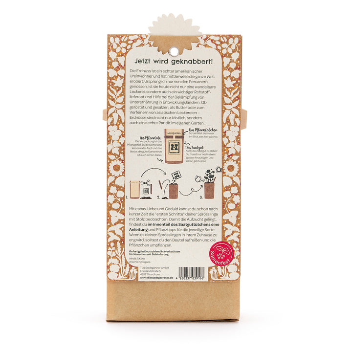 Rückseite einer Verpackung mit Anleitung und Beschreibung zur Aussaat und Pflege von Erdnuss-Pflanzen auf Deutsch, dekoriert mit Blumenmuster.