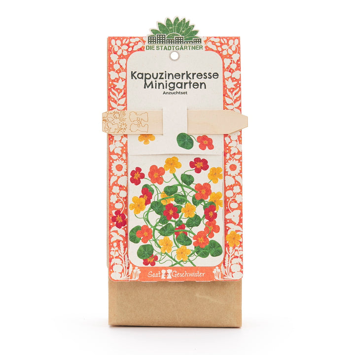 Verpackung eines Kapuzinerkresse Minigarten Anzuchtsets mit buntem Blumenmotiv und dekorativem Rand.
