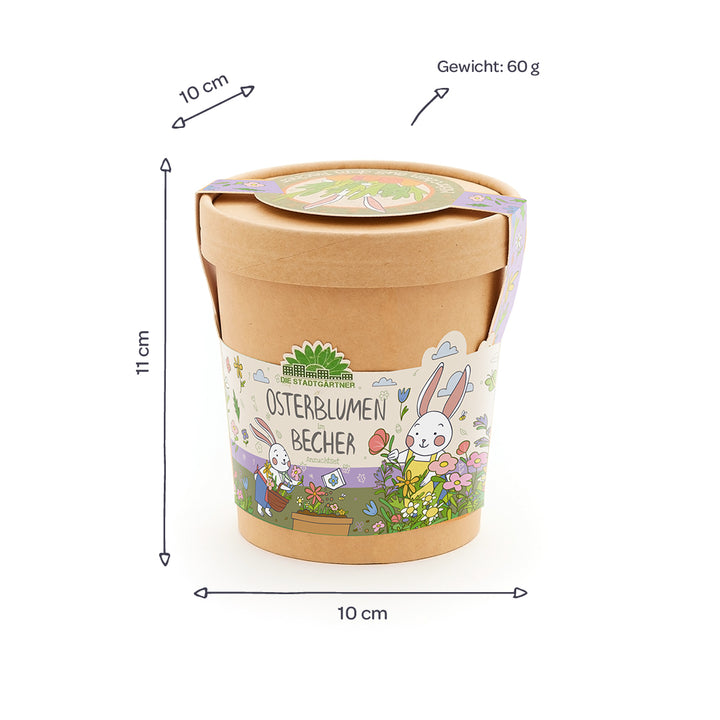 Brauner Becher mit Deckel, buntem Osterhasenmotiv und der Aufschrift „Osterblumen Becher“, daneben Maße (10 cm Durchmesser, 11 cm Höhe) und Gewicht (60 g) angegeben.