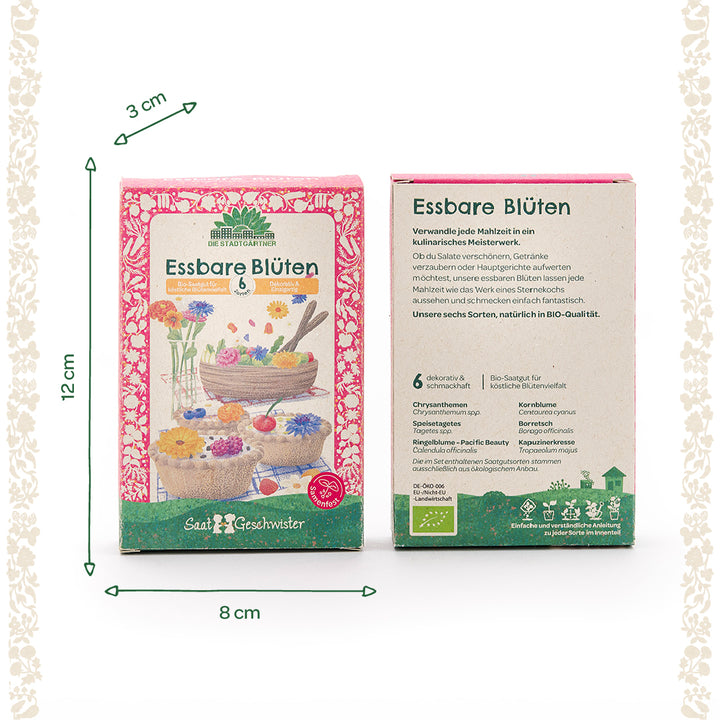 Zwei Packungen mit der Aufschrift "Essbare Blüten" von Die Stadtgärtner, jeweils mit Abbildungen von bunten Blüten auf Speisen sowie Produktinformationen und Sortenbeschreibung; Maße sind 12 cm hoch, 8 cm breit und 3 cm tief.