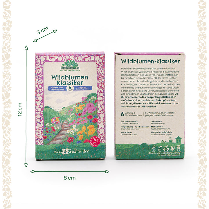 Zwei bunt gestaltete Saatgutboxen mit der Aufschrift "Wildblumen Klassiker" von Die Stadtgärtner, inklusive Größenangaben (12 cm hoch, 8 cm breit, 3 cm tief) und Blumenillustrationen auf der Vorderseite.